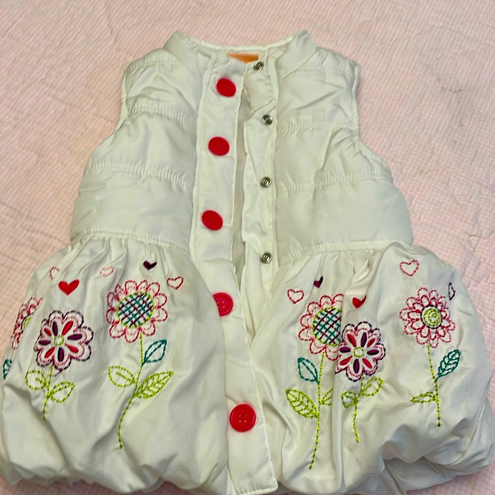 Toddler girls size 5 puffer vest with embroidered flowers on the bottom
